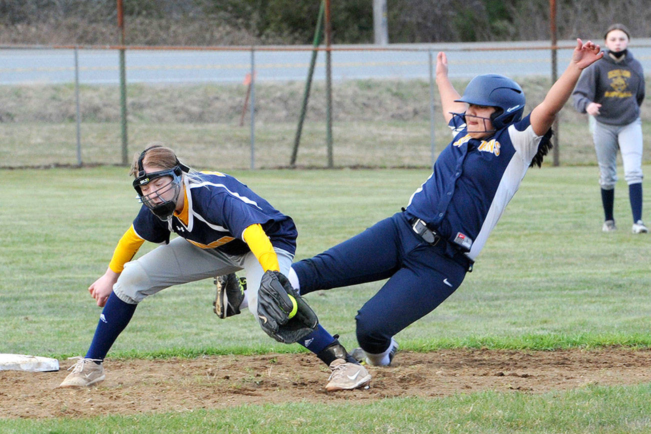 Spartan Elizabeth Soto steals second during the second game of a double header won by Forks 6 to 0.  Covering is Ilwaco short stop Justyce Patana.  Photo by Lonnie Archibald.