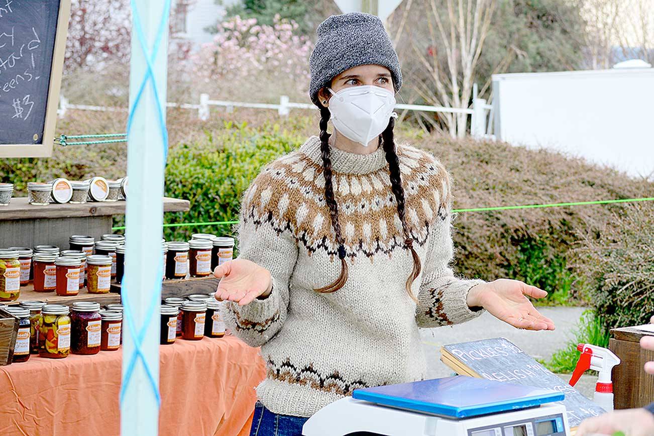 Meghan Mix of Hopscotch Farm is among dozens of vendors at the Port Townsend Farmers Market’s opening day Saturday. She had a busy day at her stand, selling salad greens, pickles and her popular beet relish. The market is on from 9 a.m. to 2 p.m. Saturdays at Tyler and Lawrence streets in Uptown Port Townsend. (Diane Urbani de la Paz/Peninsula Daily News)