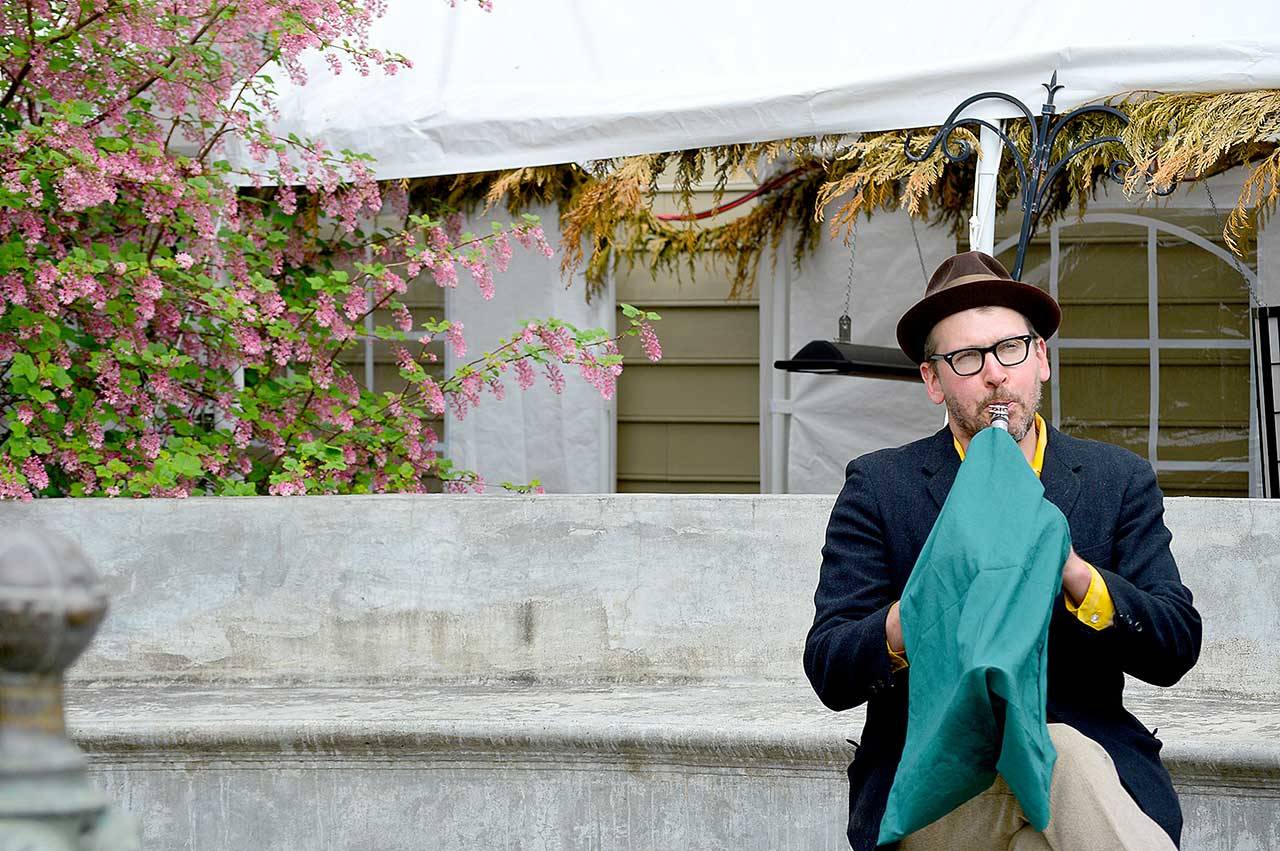 Clarinetist Jonathan Doyle, complete with an aerosol-masking instrument cover, jazzed up the Haller Fountain in downtown Port Townsend in the first “Buskers on the Block” gig. The series will showcase local musicians Thursdays and Saturdays through May. (Diane Urbani de la Paz/Peninsula Daily News)