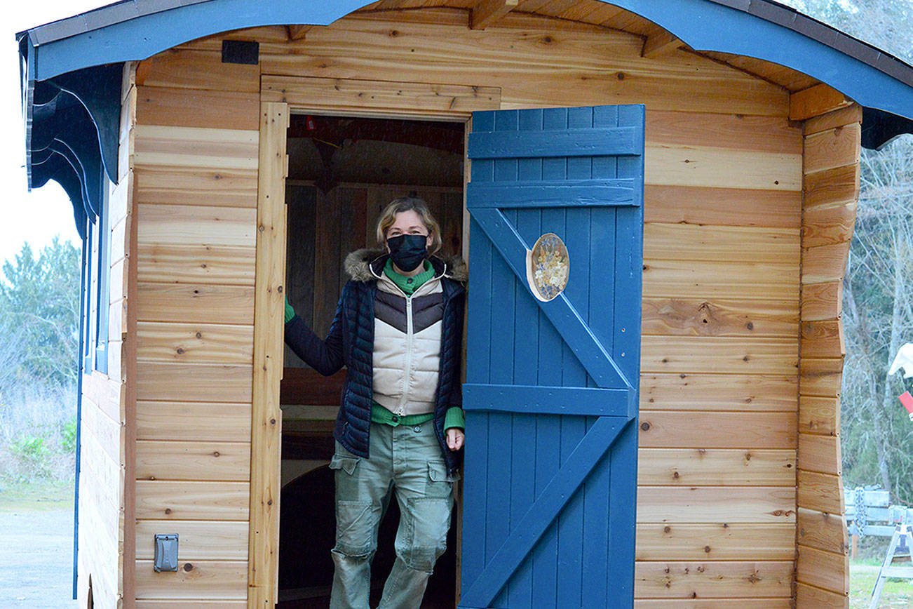 Shayna Wiseman is the delighted owner of a tiny cedar house she and volunteers constructed at the Community Boat Project in Port Hadlock. Diane Urbani de la Paz/Peninsula Daily News