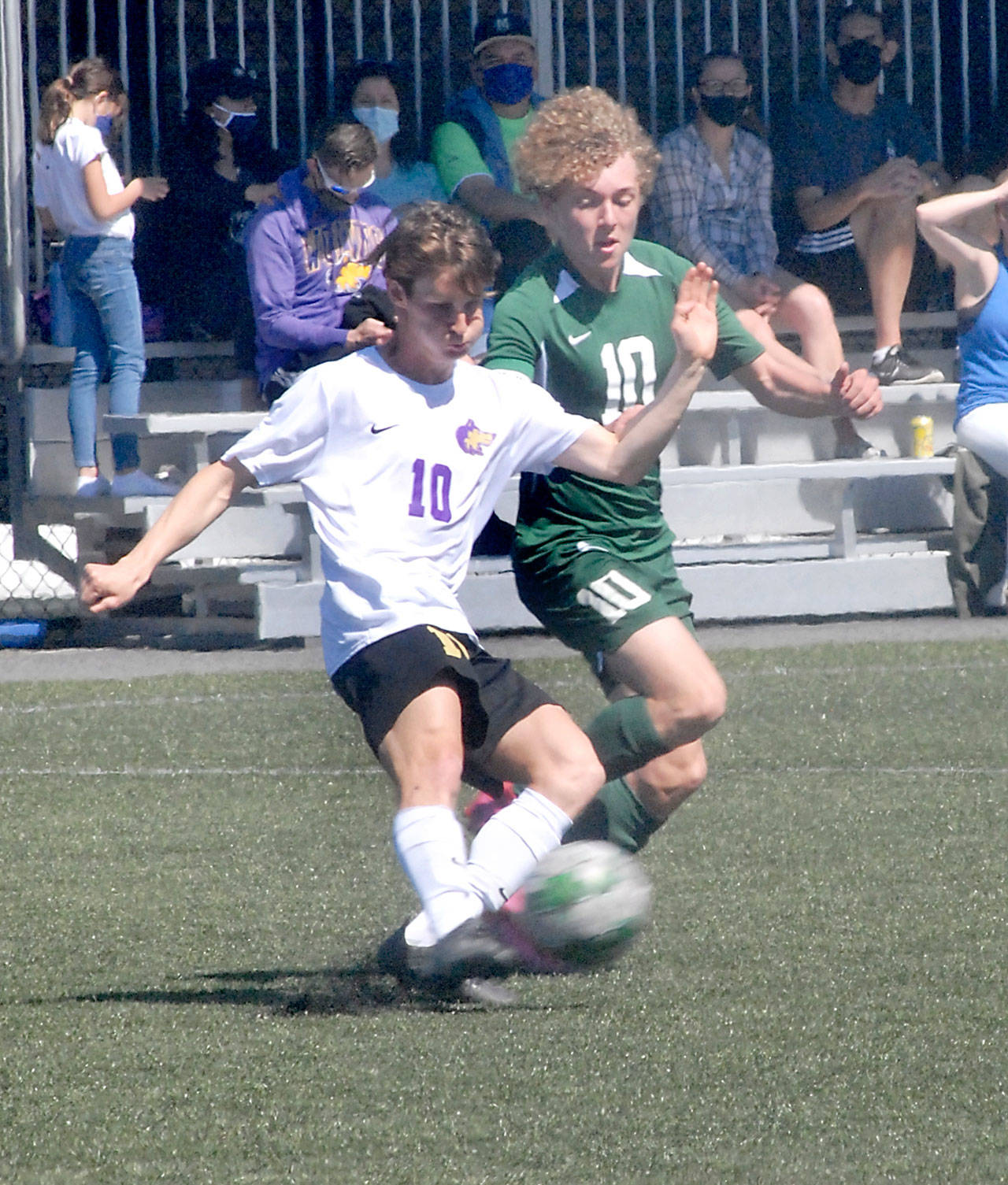 Keith Thorpe/Peninsula Daily News Sequim’s Eli Gish, left, and Port Angeles’ Damon Gundersen compete for control at midfield on Saturday at Peninsula College.