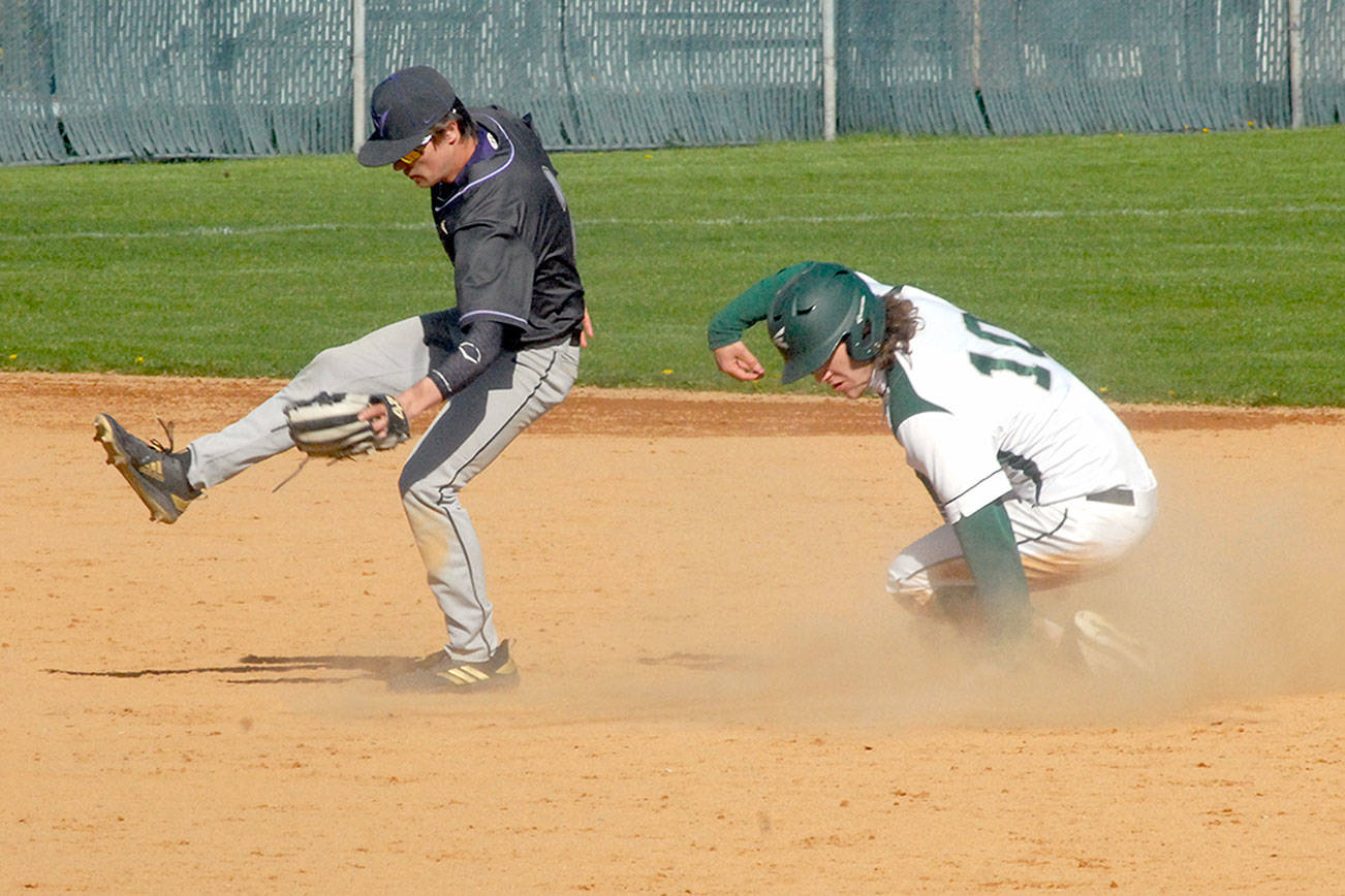 Keith Thorpe/Peninsula Daily News
Port Angeles' Ty Bradow makes it safely to second after a ball thrown to North Kitsap second baseman Zach Edwards goes wild in the second inning on Tuesday in Port Angeles.