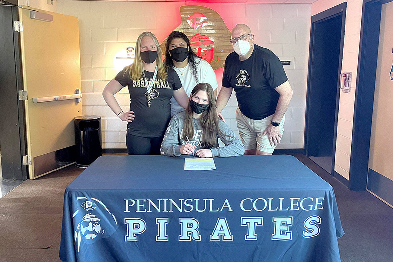 Port Angeles senior Myra Walker, seated, has signed a letter of intent to play basketball for Peninsula College. Walker is joined by from left, Peninsula head coach Alison Crumb and assistant coaches Gabi Fenumiai and Mike Knowles.