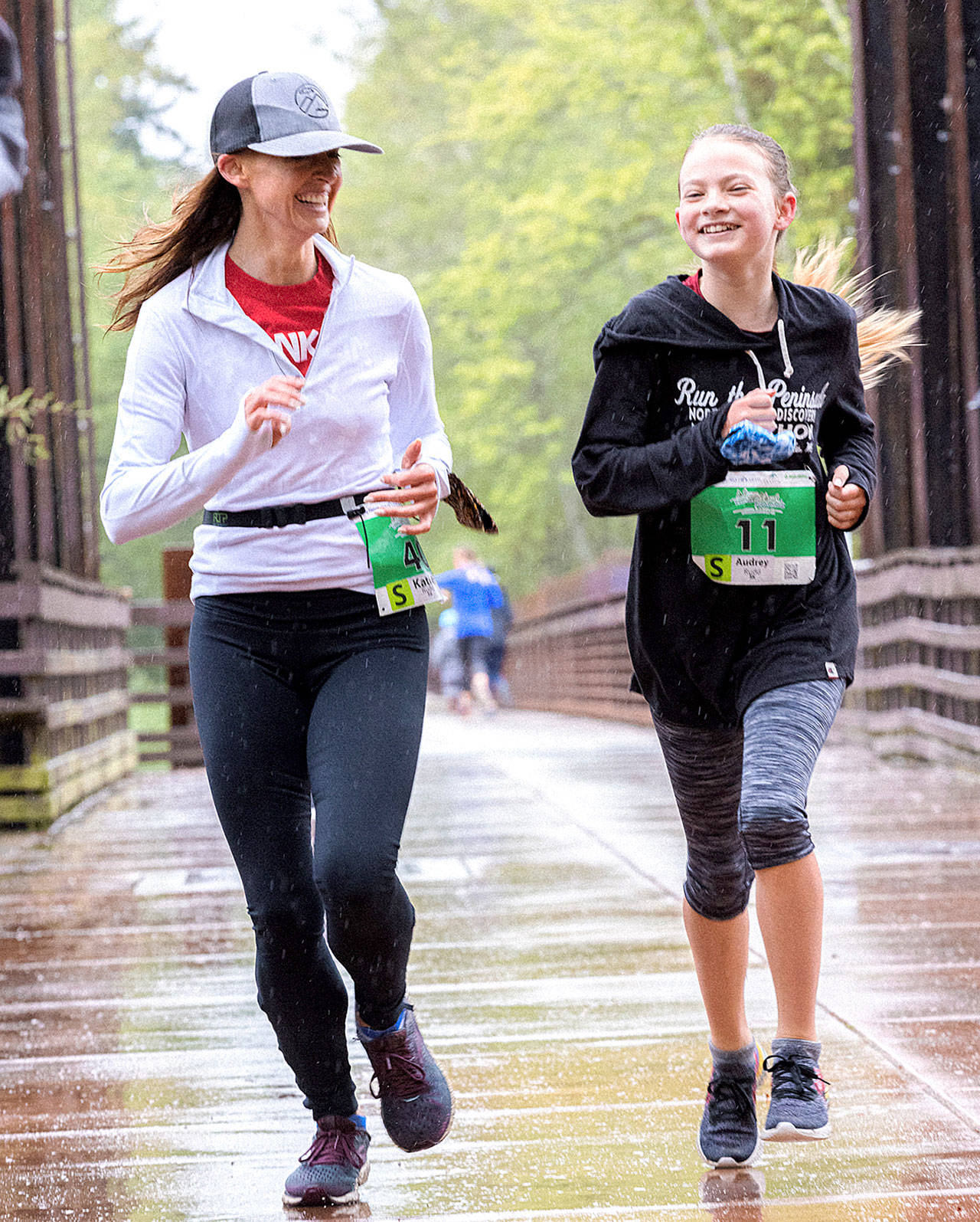 Mother and daughter, Katie and Audrey Rudd of Port Angeles, run in the 5K Railroad Bridge Run on Saturday. (Port Angeles Marathon Association)