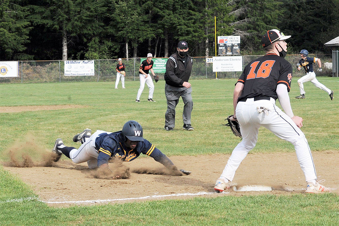 Lonnie Archibald/for Peninsula Daily News
Forks' Trey Baysinger slides into third while in the background Riley Pursley heads for second during a successful double steal against Kalama. The Spartans edged the Chinooks 4-3 to advance to the district championship.