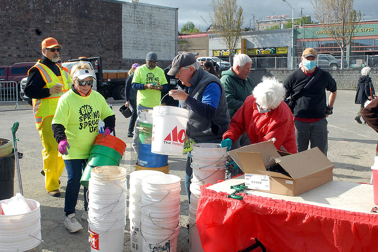 Keith Thorpe/Peninsula Daily News 

Participants in Saturday’s “Big Spring Spruce Up” pick up empty buckets for weeds and other organic waste before fanning out over downtown Port Angeles in an effort to clean up the city. A video is on the Peninsula Daily News website at www.peninsuladailynews.com.