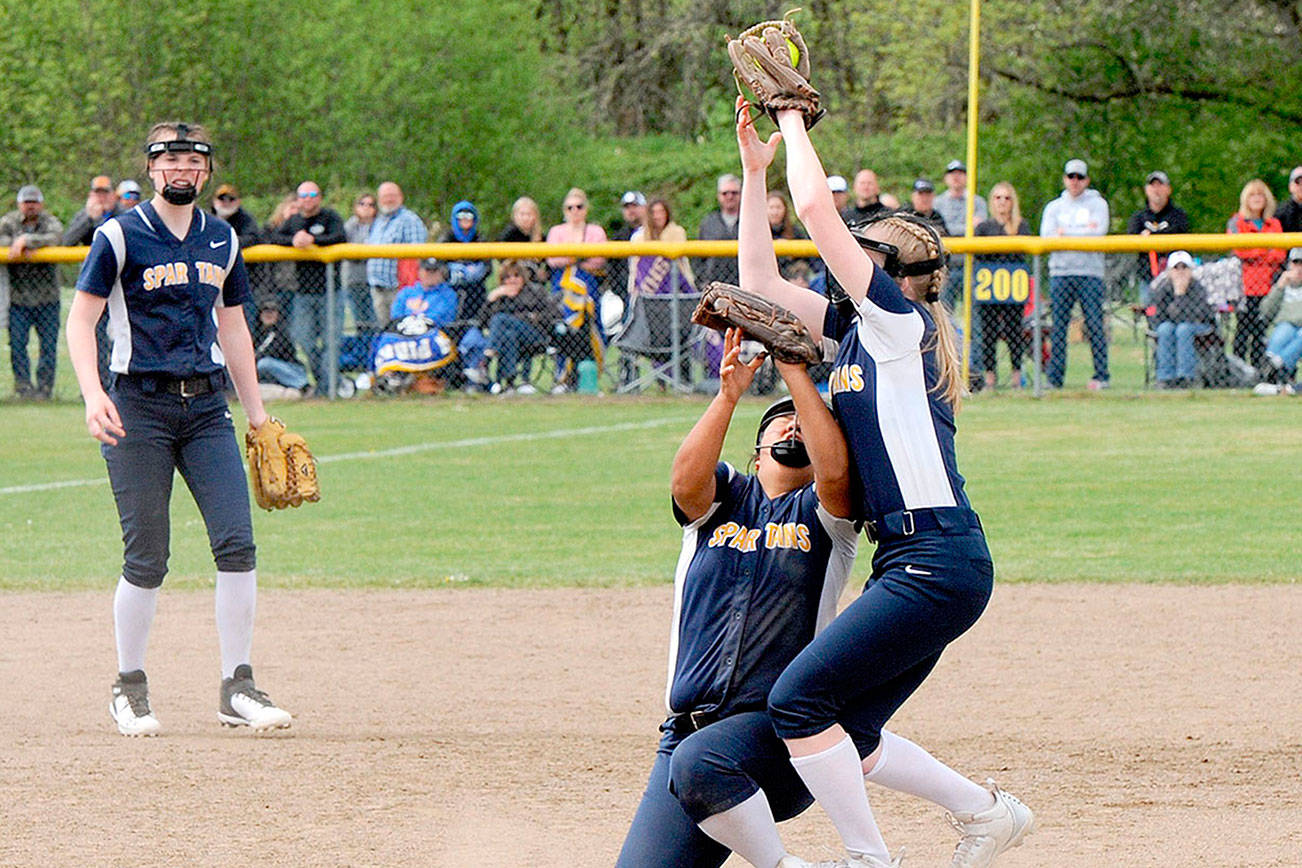 Lonnie Archibland/for the Peninsula Daily News
Spartan second baseman Kadie Wood makes the catch of an Adna fly ball for the out over shortstop Elizabeth Soto.  Forks placed second in district after falling to Adna 4-3 in extras innings.