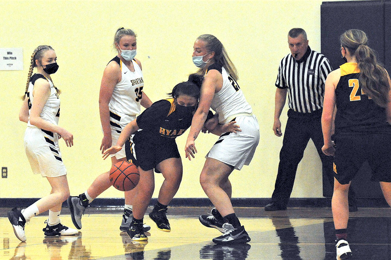 Spartans from left Rylee Bouchard, Kyra Neel and Chloe Leverington with only one practice since softball season put the pressure on this North Beach player Tuesday evening in the Forks auxiliary gym where Forks defeated the Hyaks 71 to 35.  Photo by Lonnie archibald.