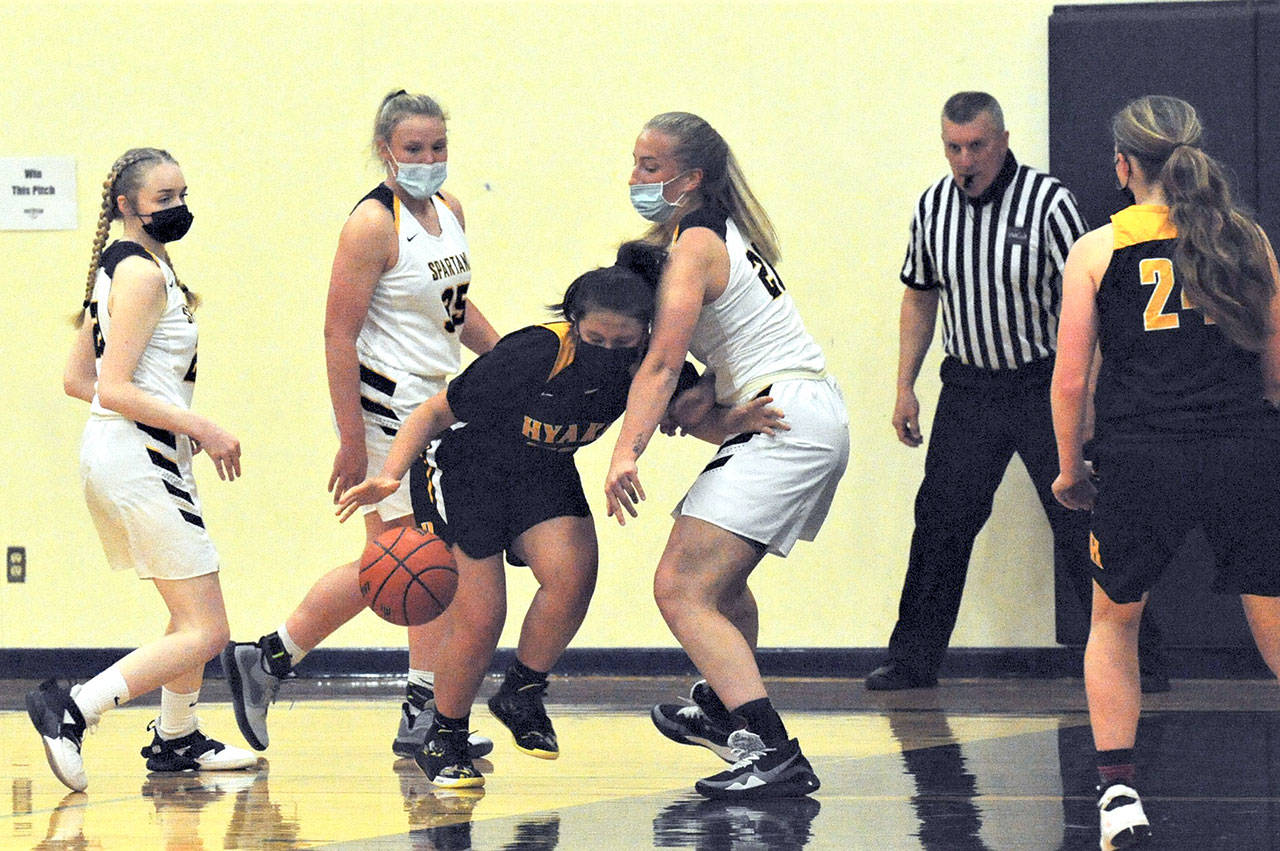 Forks players, from left, Rylee Bouchard, Kyra Neel and Chloe Leverington put the pressure on a North Beach player Tuesday evening in the Forks Auxiliary Gym. (Lonnie Archibald/for Peninsula Daily News)