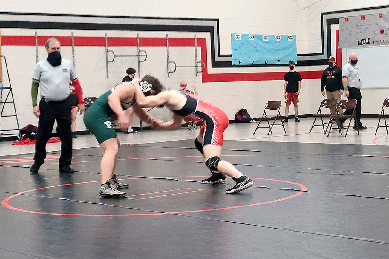 Port Angeles' Daniel Cable, left, and East Jefferson's Kyle Caldwell square off in a 195-pound match during a dual-meet at Kingston High School. Caldwell, who placed second at state in 2020, won the match but the Roughriders won both duals. (Port Angeles Wrestling)