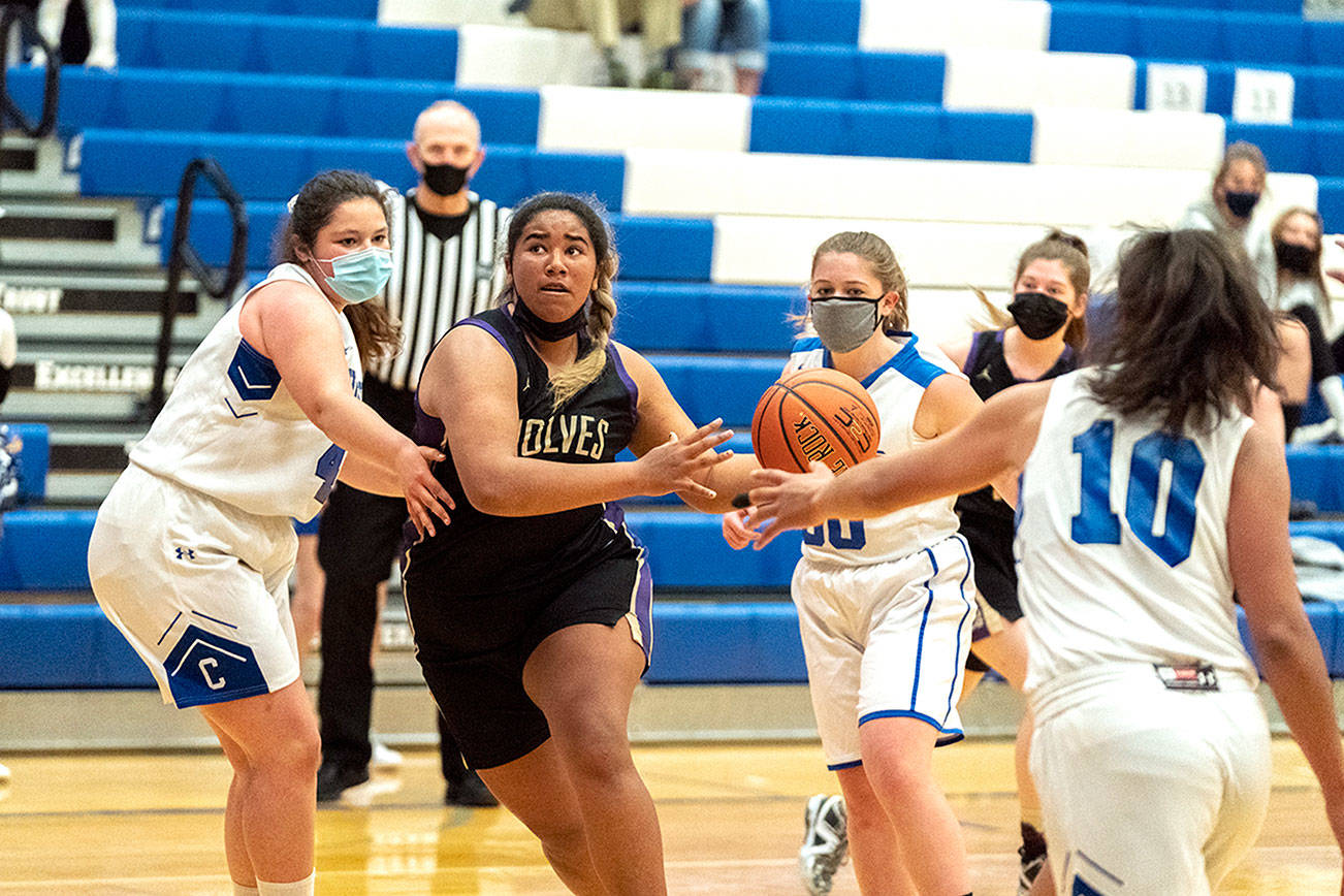 Steve Mullensky/for Peninsula Daily News

Sequim's Jelissa Julmist keeps her eyes on the basket as she drives for a score against East Jefferson's Alyssa Vandenberg, left, Shelby Theibelt, 30, and Gina Brown during a Saturday afternoon game played in Chimacum.