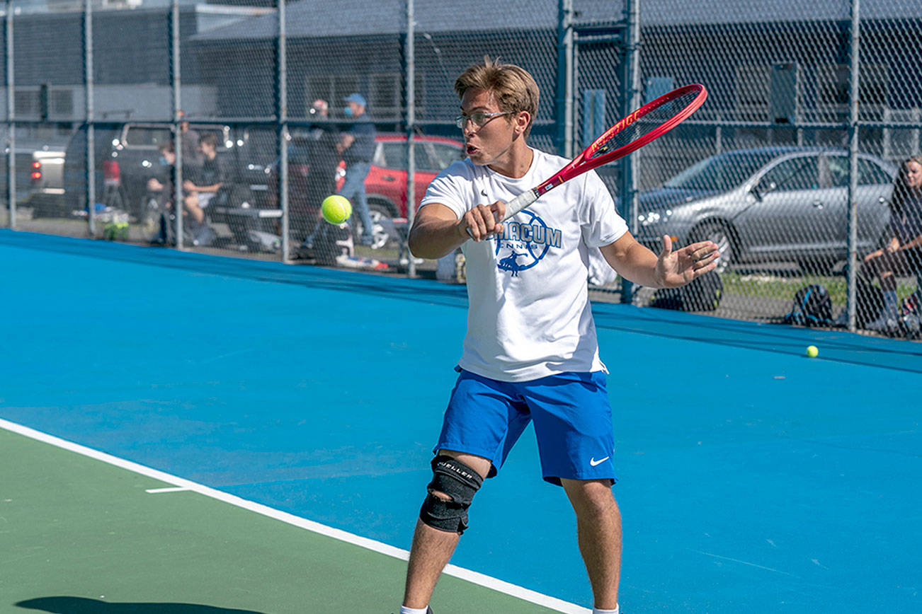 Steve Mullensky/for Peninsula Daily News

East Jefferson's Carter Cameron hits a backhand return against Klahowya's Evan Cole during a Tuesday afternoon match in Chimacum.