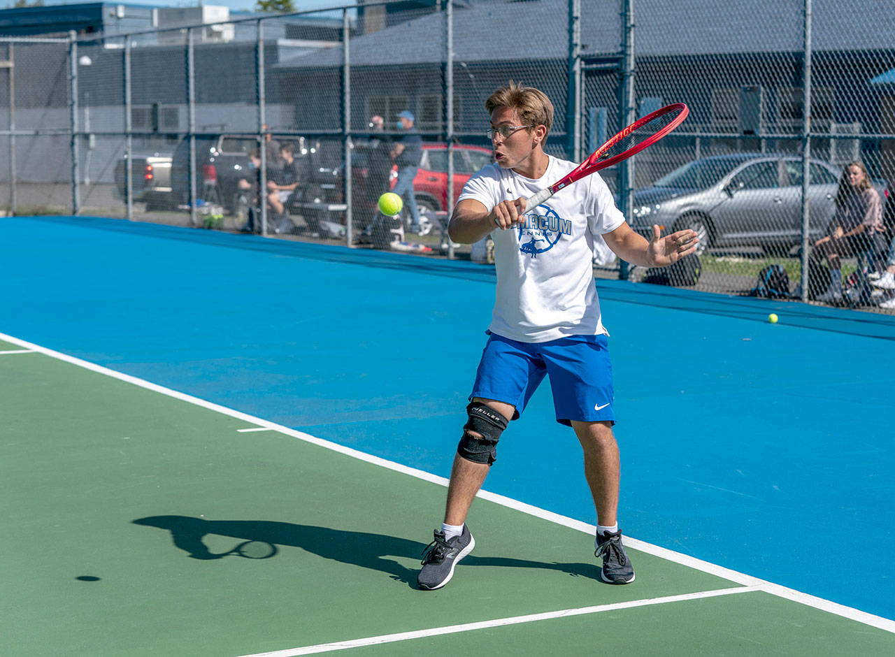 East Jefferson’s Carter Cameron hits a backhand return against Klahowya’s Evan Cole during a Tuesday afternoon match in Chimacum. (Steve Mullensky/for Peninsula Daily News)