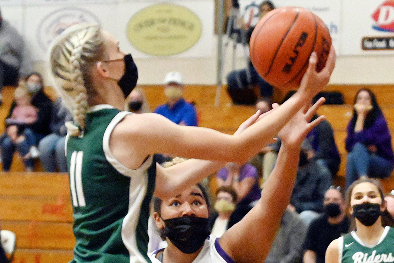 Michael Dashiell/Olympic News Group
Port Angeles' Millie Long goes up for a layup while defended by Sequim's Jelissa Julmist during the Roughriders' 67-58 win over the Wolves on Wednesday.