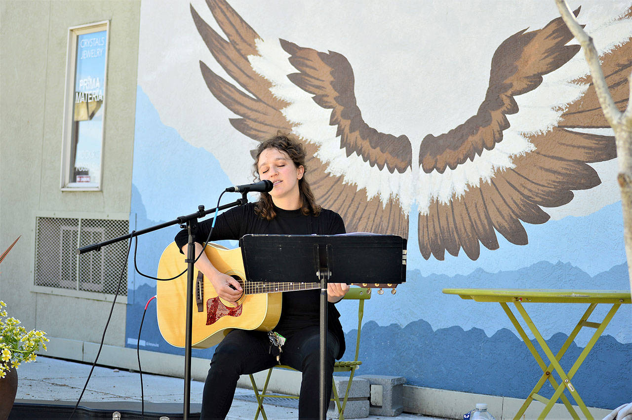 Port Townsend entertainer Phina Pipia is pictured playing a free concert on the Tyler Street Plaza last Thursday; she’s slated to return at 2 p.m. this Thursday for another Buskers on the Block performance sponsored by the Main Street Program. The hour-long gigs in downtown Port Townsend showcase local artists such as Pipia, who has just returned to public performances after a year. She plays original songs including tracks from her new album and songbook, “Outside of the Movies.” More awaits at phinapipia.com. (Diane Urbani de la Paz/Peninsula Daily News)