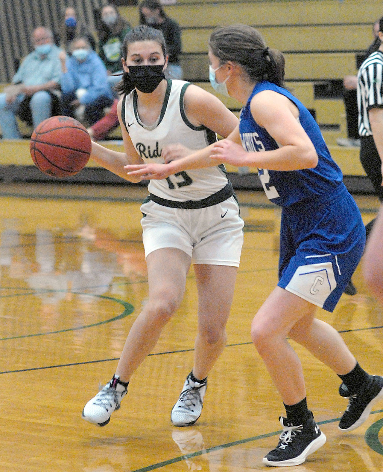 Port Angeles’ Bailee Larson, left, prepares to pass around the defense of East Jefferson’s Aurin Asbell on Tuesday night at Port Angeles High School. (Keith Thorpe/Peninsula Daily News)