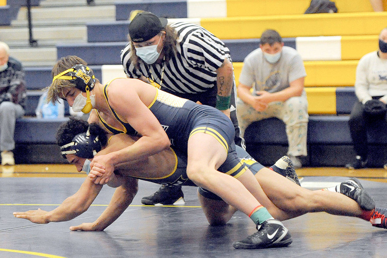 Lonnie Archibald/for Peninsula Daily News 
Forks' Jake Weakley (top) pinned Ilwaco's Keegan Kemmer in the 152-pound class Wednesday evening in Forks. Forks' Mike Blair officiated the match.