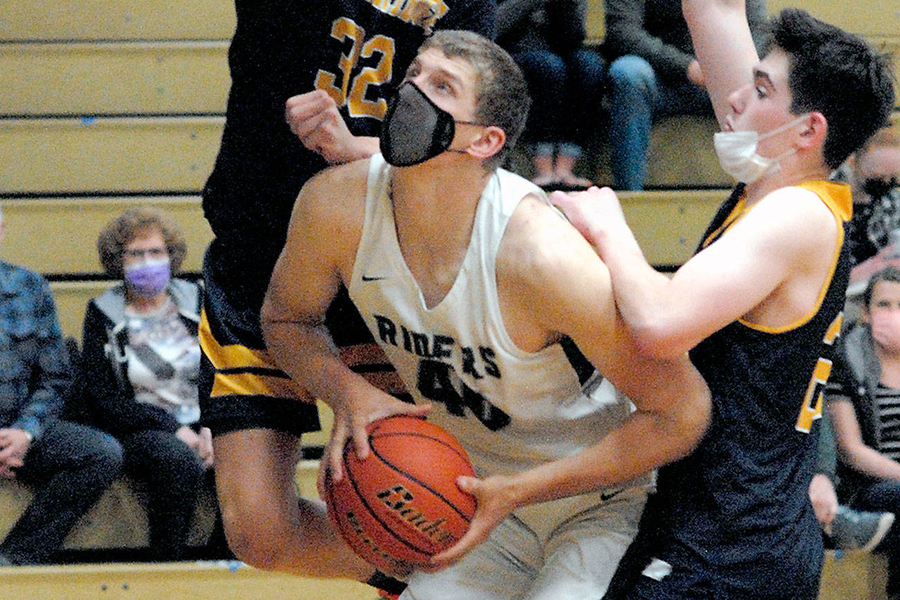 Keith Thorpe/Peninsula Daily News
Port Angeles' John Vaara, center, is surrounded by Bainbridge defenders Luike Lavigne, left, and James Carey during the third quarter on Thursday in Port Angeles.