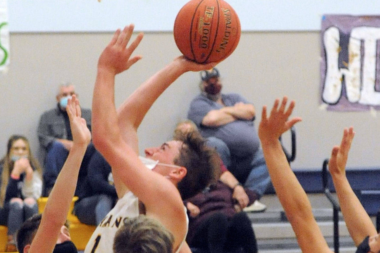 Spartan Riley Pursley scores over a host of Hyaks Thursday evening in Forks where the Spartans defeated North Beach 72 to 35.  Photo by Lonnie Archibald.