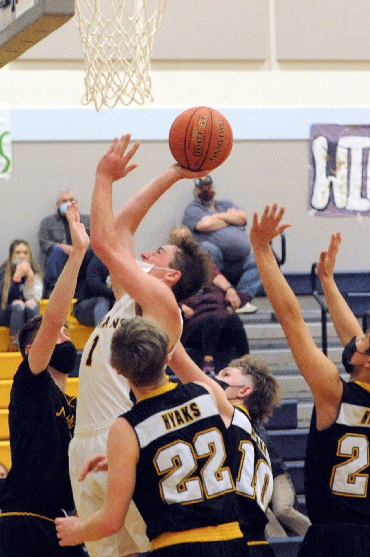 Forks’ Riley Pursley scores over a host of Hyaks Thursday evening in Forks where the Spartans defeated North Beach 72-35. (Lonnie Archibald/for Peninsula Daily News)