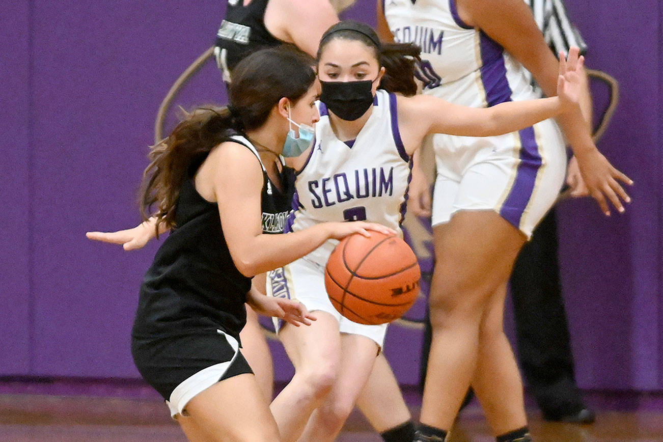 Michael Dashiell/Olympic Peninsula News Group
Sequim's Hannah Bates cuts off a Klahowya opponent's drive to the basket during the Wolves' 68-8 win over the Eagles on Tuesday.