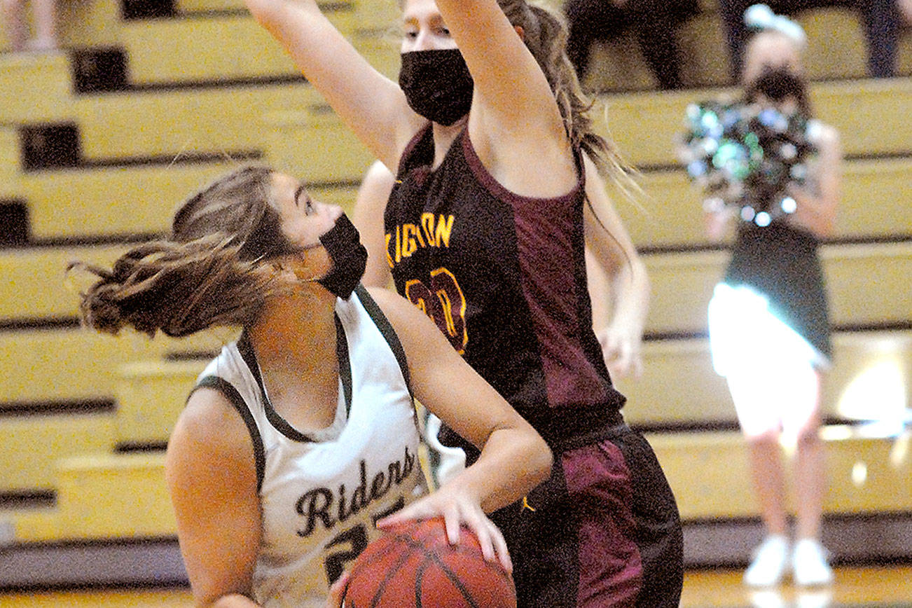 Keith Thorpe/Peninsula Daily News
Port Angeles' Eve Burke, left, looks for a shot around Kingston's Ellee Brockmanm on Friday night at Port Angeles High School.