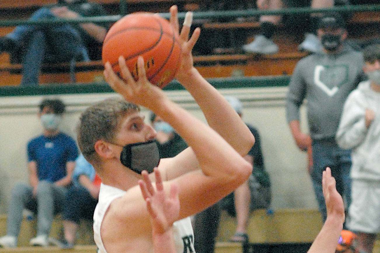 Keith Thorpe/Peninsula Daily News
Port Angeles' John Vaara aims for the basket over the heads on North Kitsap's Colton Bower, front, and Johny Olmsted on Thursday at Port Angeles High School.