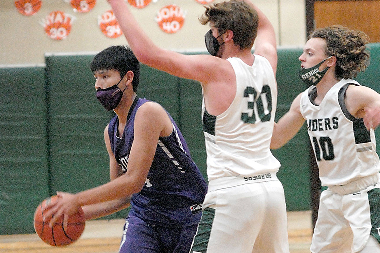 Keith Thorpe/Peninsula Daily News
Sequims Isiah Moore, left, looks to pass under pressure from Port Angeles' Wyatt Dunning, center, and Dru Clark on Saturday at Port Angeles High School.