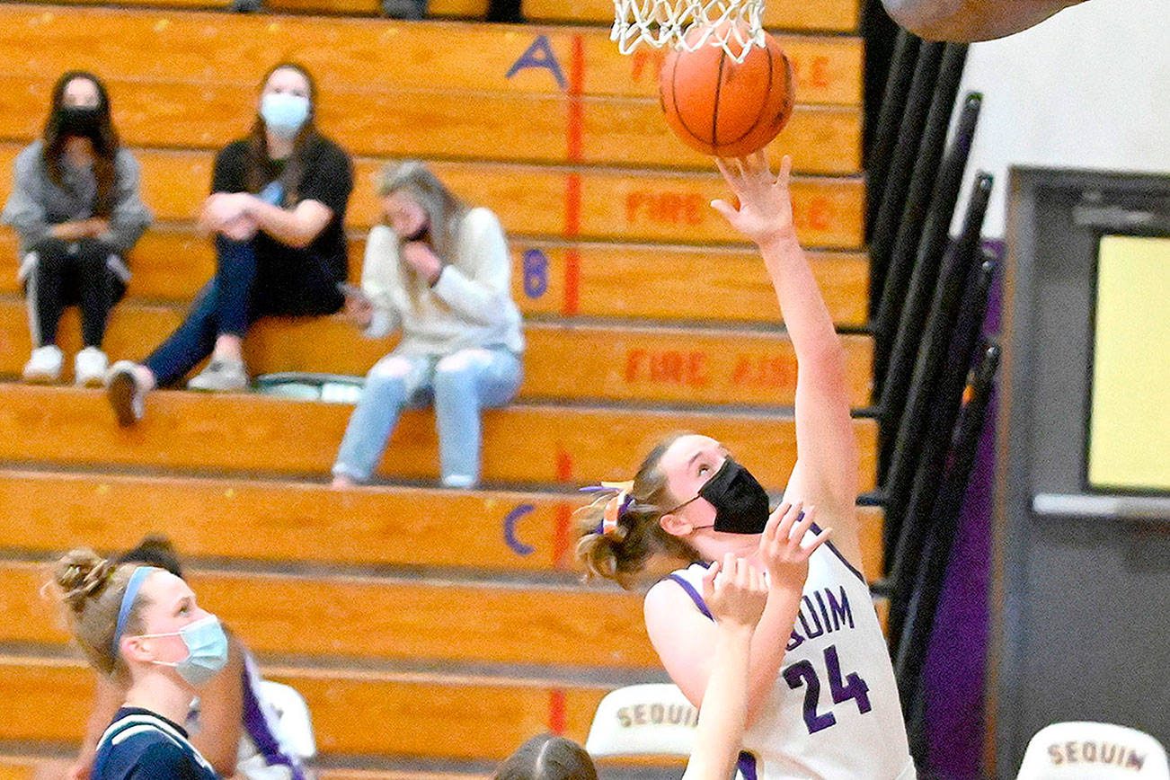 Sequim's Malory Morey goes up for a shot against Bainbridge on Saturday. Sequim won 66-17. (Michael Dashiell/Olympic Peninsula News Group)