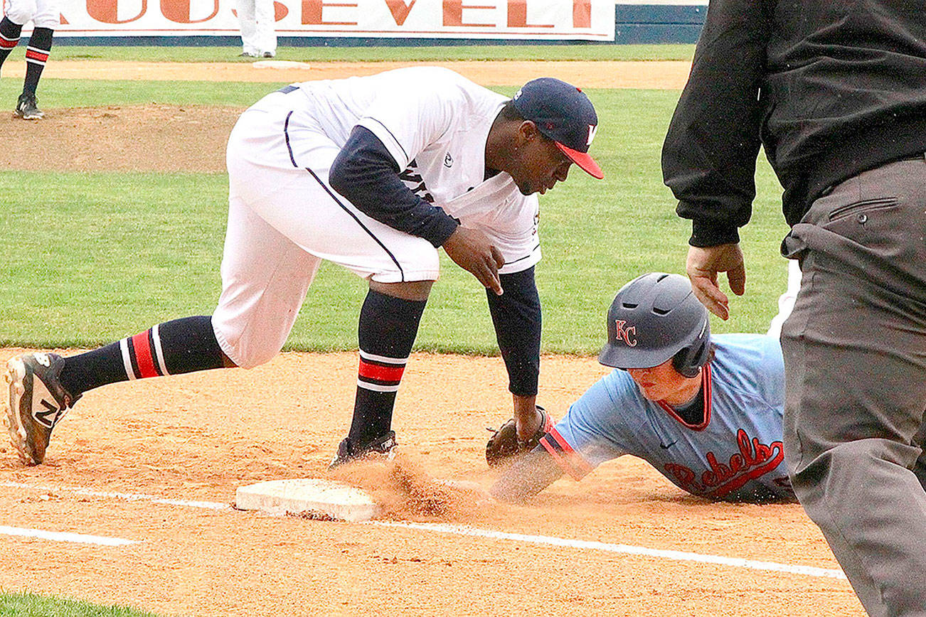 Dave Logan/for Peninsula Daily News
Wilder Sr. first baseman Trey Baysinger tags a baserunner in Wilder's doubleheader against the Kitsap Rebels on Sunday at Civic Field. Wilder won both games.