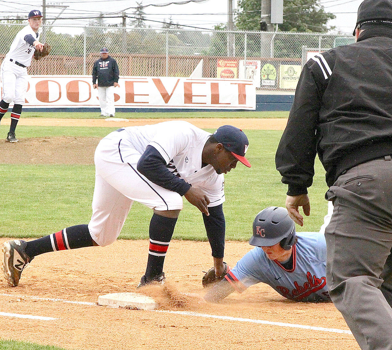 Wilder Sr. first baseman Trey Baysinger tags a baserunner in Wilder’s doubleheader against the Kitsap Rebels on Sunday at Civic Field. Wilder won both games. (Dave Logan/for Peninsula Daily News)