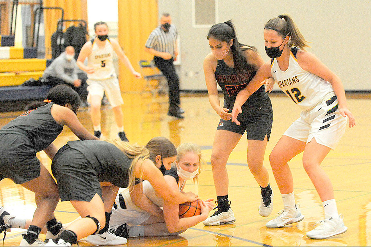 Lonnie Archibald/for Peninsula Daily News
Hustling for the ball Monday in Forks are Napavine's Rae Sisson (left) and Forks' Kadie Wood. Looking on from the right are Napavine's Natalya Marcial and Forks'  Kray Horton (12). Napavine got by the Spartans 54-52 to end Forks' season.