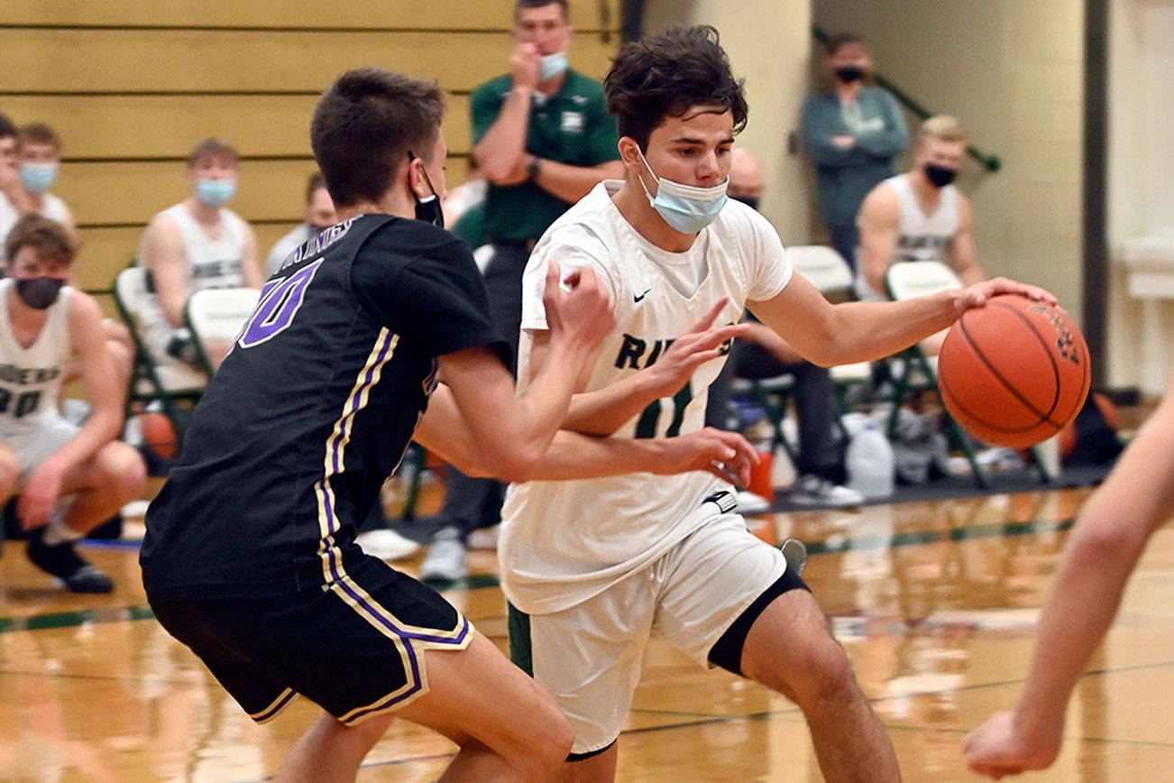 Michael Dashiell/Olympic Peninsula News Group

Port Angeles' Xander Maestas drives while defended by North Kitsap's Cade Orness during the Riders' 75-65 Olympic League Championship loss Wednesday. Maestas scored a game-high 28 points.