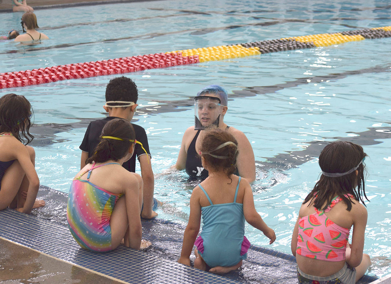 Kate Henninger, YMCA of Sequim Aquatics Director, teaches youngsters at the YMCA’s Spring Break Swim Camp earlier this year. She leads a free Safety Around Water Camp for youths of ages 6-12 this June. (Photo courtesy of YMCA of Sequim)