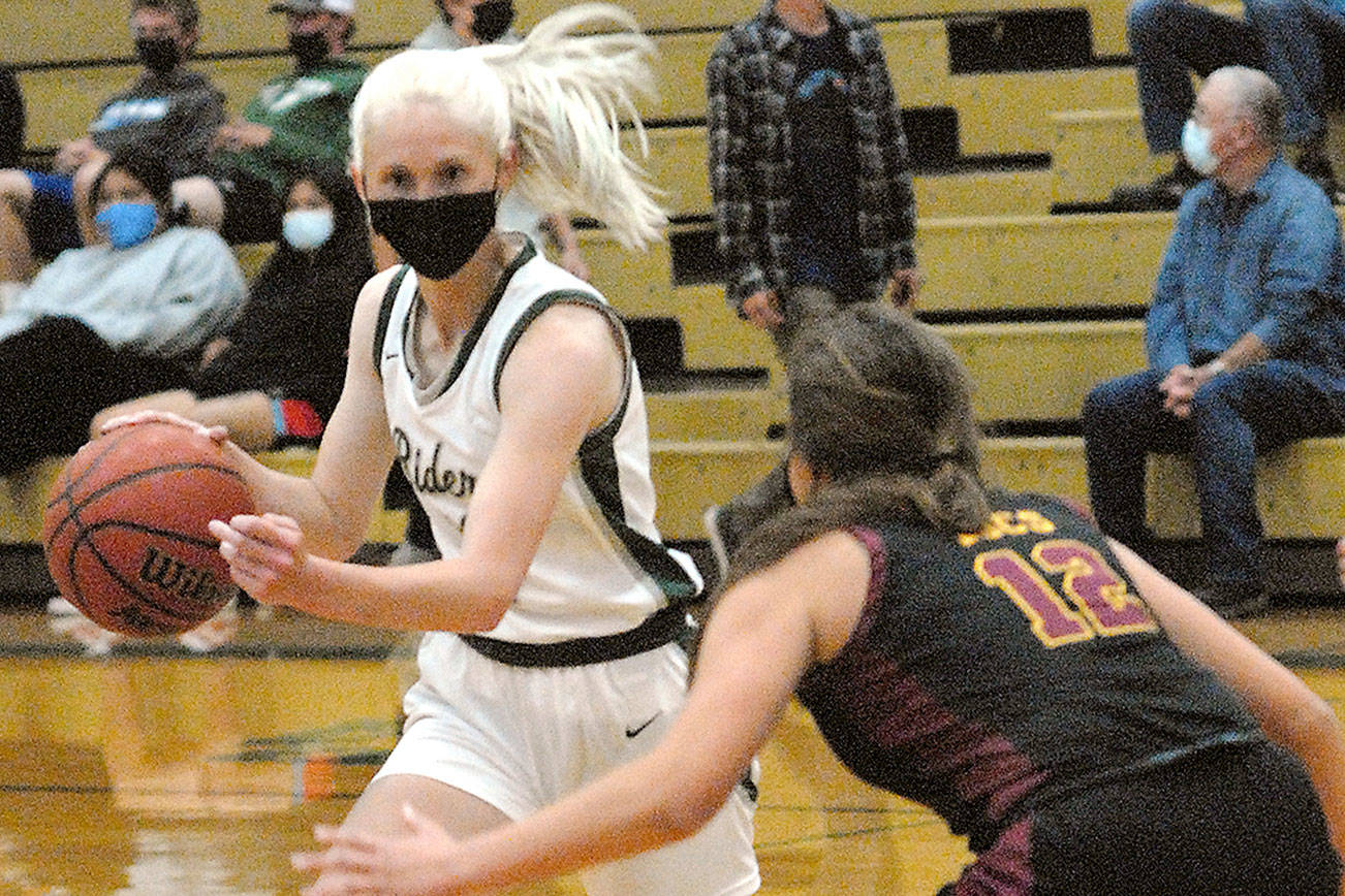 Keith Thorpe/Peninsula Daily News
Port Angeles' Millie Long, left. drives around Kingston's Brianna Jorgensen in Port Angeles in May. Long was named the Olympic League 2A girls MVP.