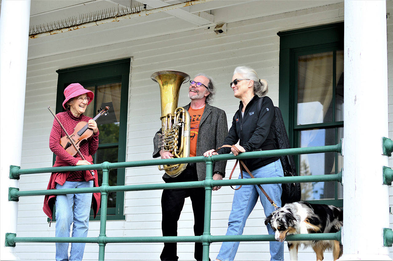 Kristin Smith, Mike McLeron and Gwen Franz, posing with her dog Hugo, are among the teachers who will host a pay-what-you-can music camp outdoors at Fort Worden State Park this summer. The first session starts June 28. Signup is available at YEAmusic.org. (Diane Urbani de la Paz/Peninsula Daily News)