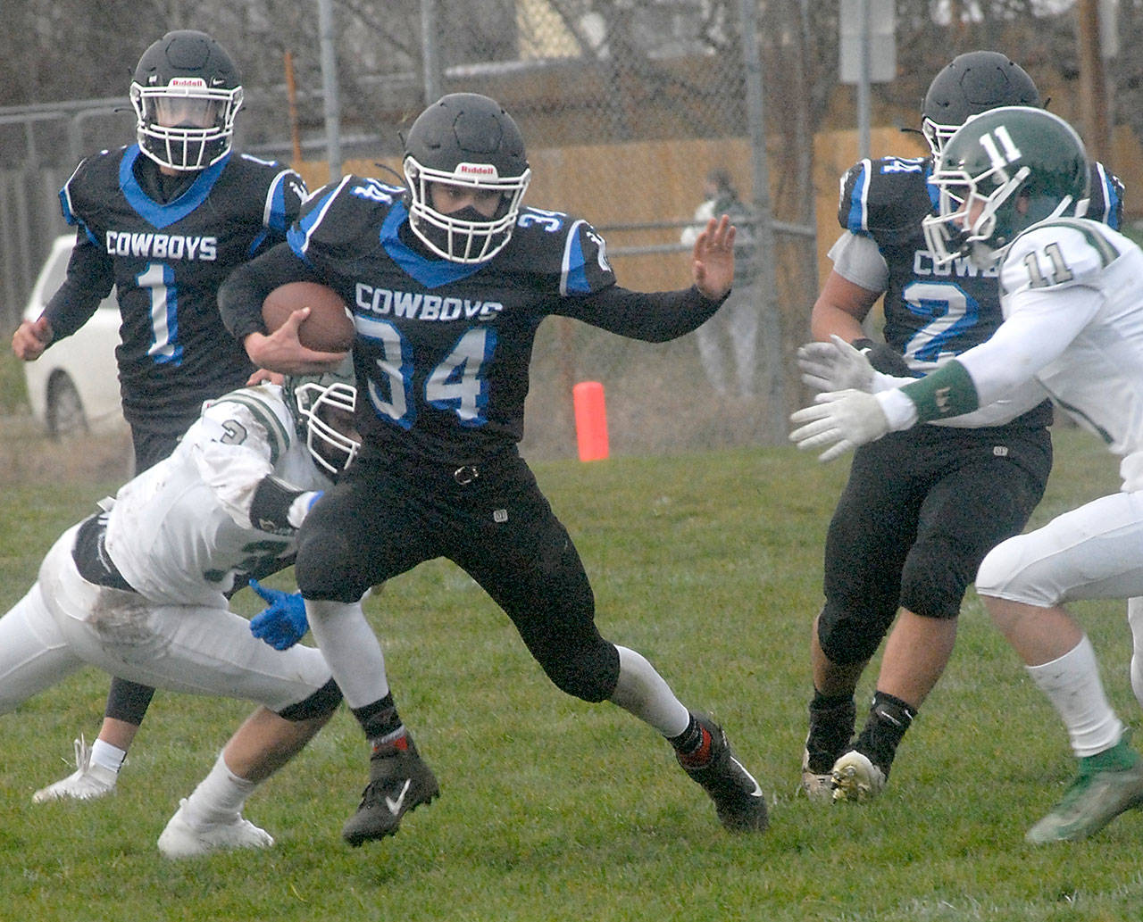 Logan Massie of East Jefferson is surrounded by Port Angeles’ Kameron Meadows, left, and Jacob Felton, right, as Massie is backed up by teammates Hunter Cerna, left rear, and Anton Jones during a February game in Port Angeles. East Jefferson is looking for a new head coach after the resignation of Patrick Gaffney. (Keith Thorpe/Peninsula Daily News)