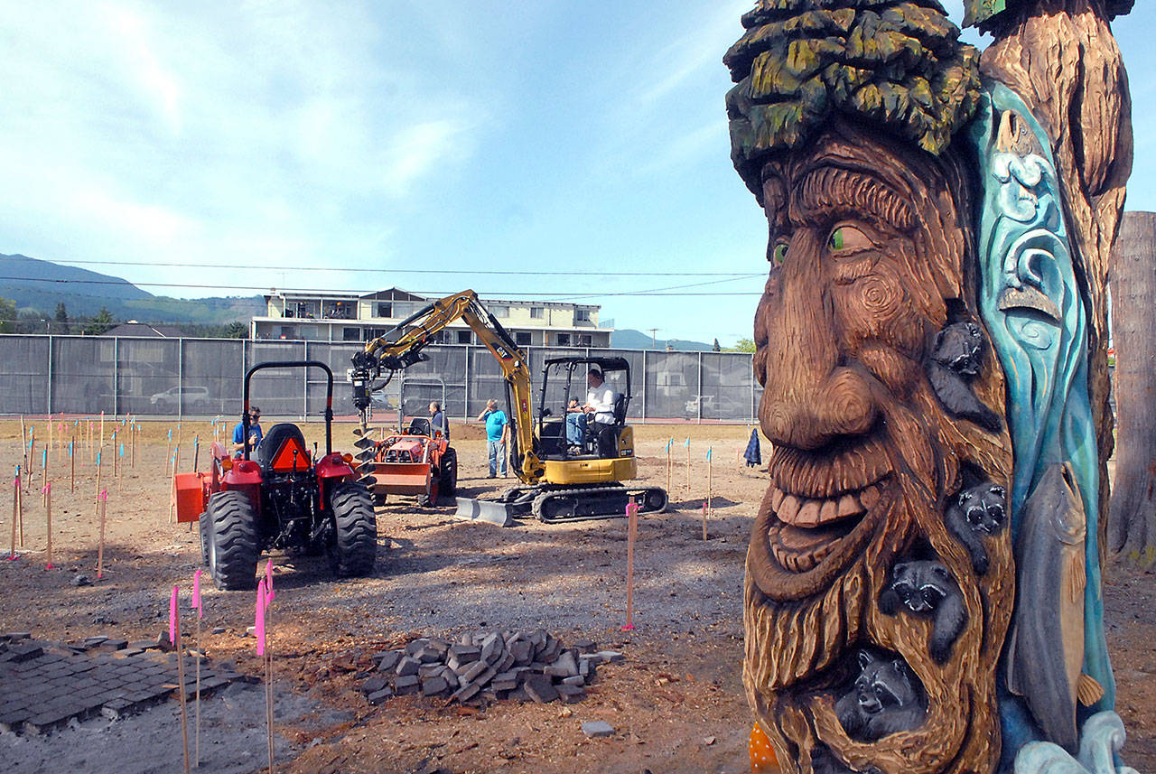 Volunteers bore holes and prepare the site on Friday for the beginning of a community build of the Generation II Dream Playground, scheduled to begin on Tuesday, at Erickson Playfield in Port Angeles. (Keith Thorpe/Peninsula Daily News)