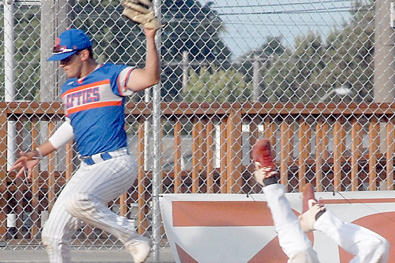 Keith Thorpe/Peninsula Daily News
Lefties third baseman Ricardo Amavizca leaps up for the ball as Driveline's Thomas Rudinsky slides into base during the third inning on Friday night at Port Angeles Civic Field.