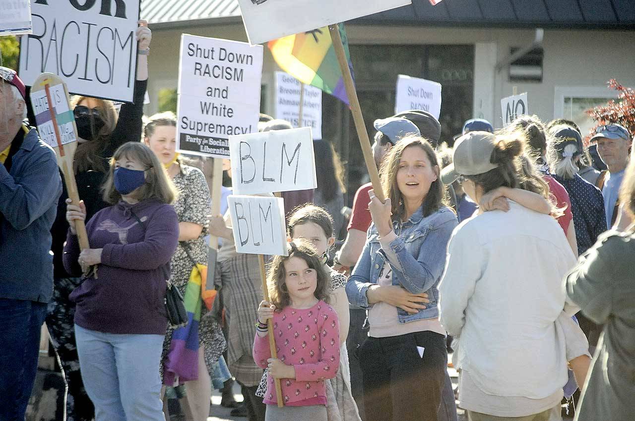 Mariia Bush stands with her two daughters, Madison, 9, and Avery, 6, during the Juneteenth Protest Against Racism and Hate on Saturday in downtown Sequim. (Matthew Nash/Olympic Peninsula News Group)