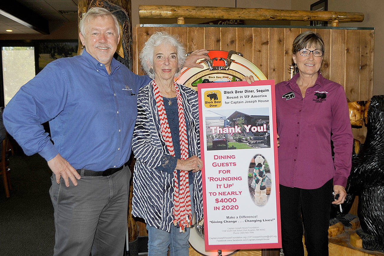 Over four years, Black Bear Diner customers have donated to the Captain Joseph House Foundation to support families of fallen soldiers. Last week, foundation executive director Betsy Reed Schultz shared a sign thanking the restaurant with owner Bret Wirta and manager Linda Donaghay accepting the sign. Sequim Gazette photo by Matthew Nash