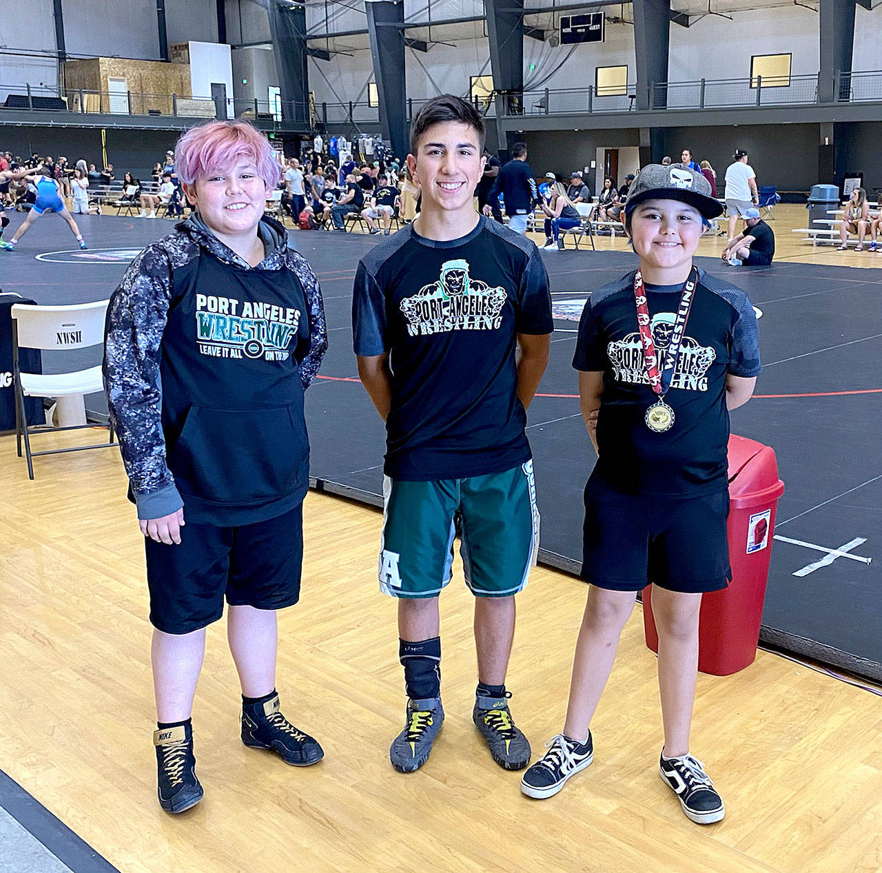 From left, Christian Snavely, Phoenix Flores and Chloe Snavely of Port Angeles wrestled at the Washington State Wrestling Association Kids Folkstyle state championships this past weekend in Centralia. (Courtesy photo)