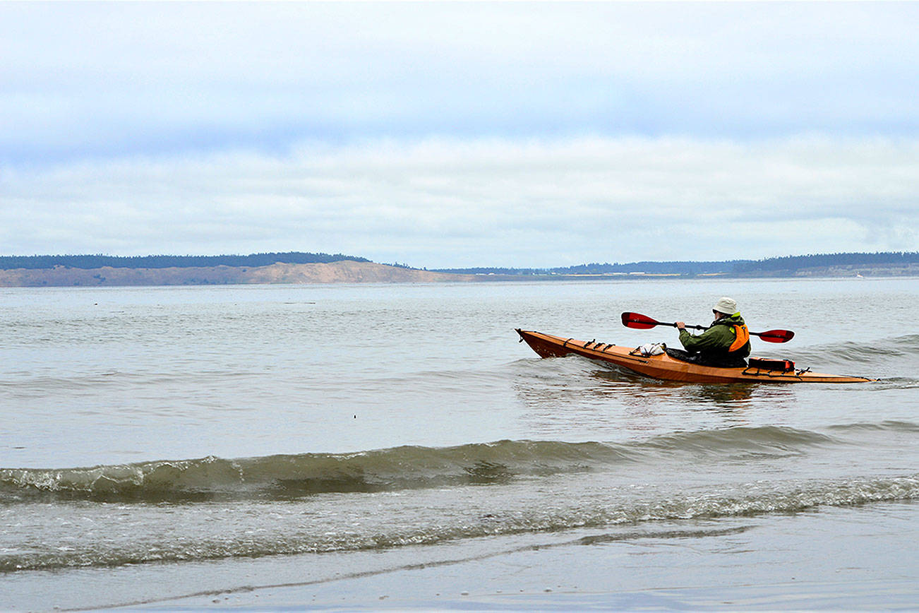 Roy Walker of Port Townsend stays close to shore as he launches his kayak from North Beach County Park on Wednesday morning. Hugging the shore and staying mindful of wind and weather changes are crucial, emergency responders say. Diane Urbani de la Paz/Peninsula Daily News