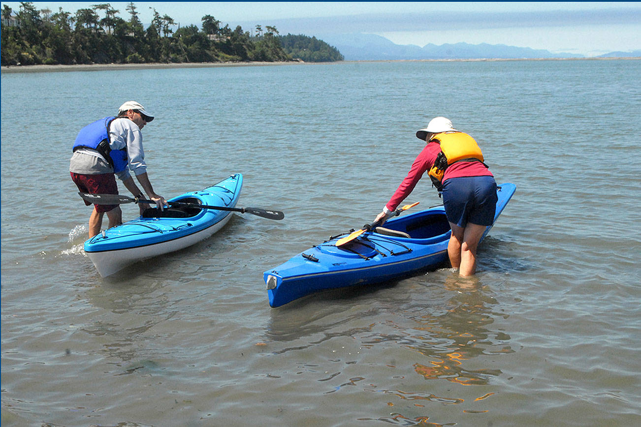 Kayakers Ray Hebert, left, and his wife, Gail Hebert, both of Port Angeles, get ready for a paddle on Dungeness Bay north of Sequim from Cline Spit County Park last week before a heat wave began on the North Olympic Peninsula. (Keith Thorpe/Peninsula Daily News)