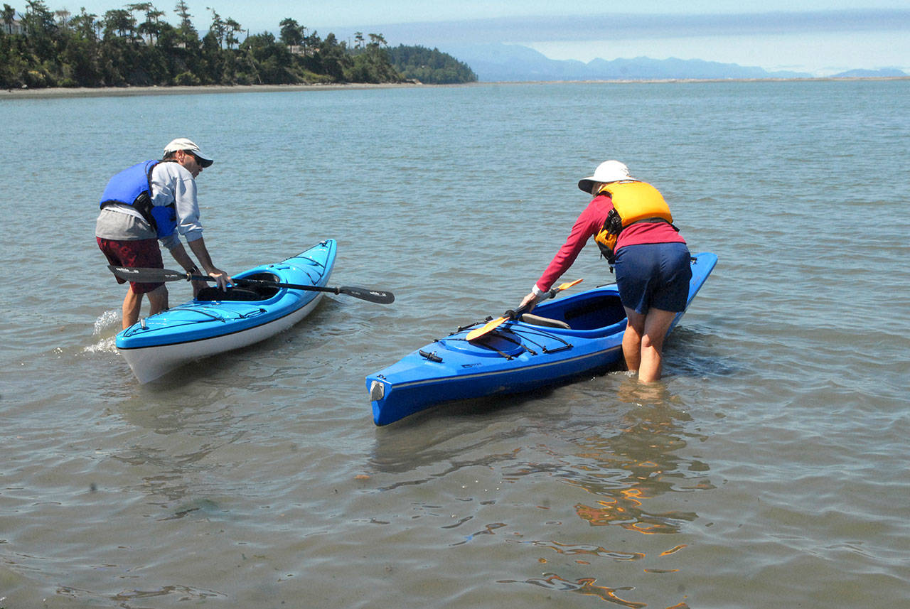 Kayakers Ray Hebert, left, and his wife, Gail Hebert, both of Port Angeles, get ready for a paddle on Dungeness Bay north of Sequim from Cline Spit County Park last week before a heat wave began on the North Olympic Peninsula. (Keith Thorpe/Peninsula Daily News)