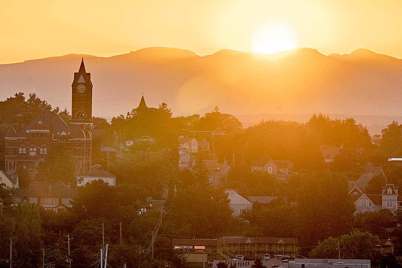 The sun rises behind the Jefferson County Courthouse in Port Townsend, bringing with it a heat advisory for the eastern Strait of Juan de Fuca. The National Weather Service’s excessive heat warning will be in effect until 9 p.m. Monday. (Steve Mullensky/For Peninsula Daily News)