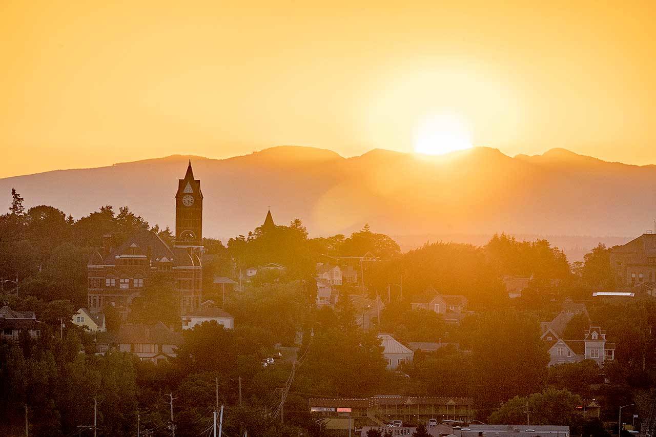 The sun rises behind the Jefferson County Courthouse in Port Townsend, bringing with it a heat advisory for the eastern Strait of Juan de Fuca. The National Weather Service’s excessive heat warning will be in effect until 9 p.m. Monday. (Steve Mullensky/For Peninsula Daily News)