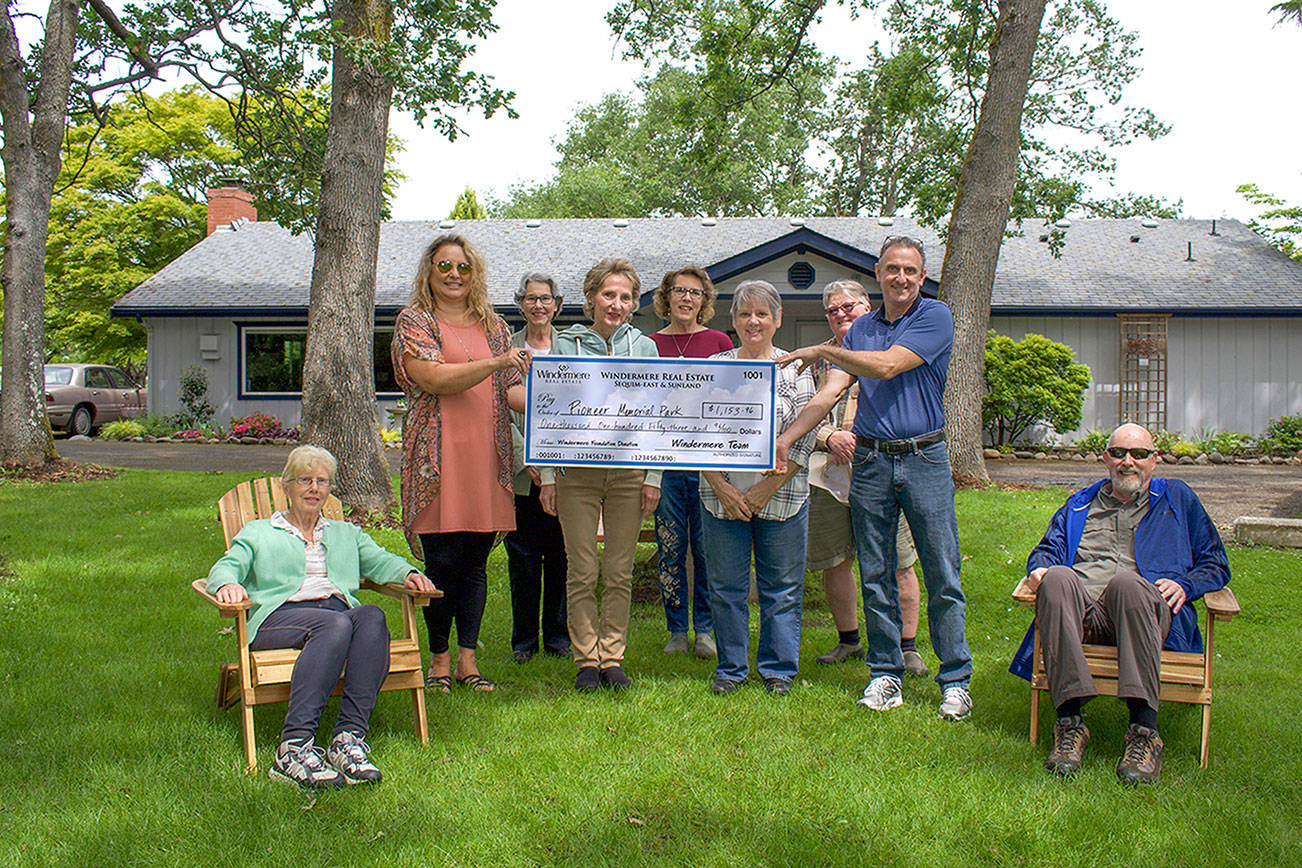 Raffle winners Mary and Steve Herbel, enjoy their new Adirondack chairs while, from left to right, Dollie Sparks, Arlene Sawyer, Vina Winters, Suzan Mannisto, Joan Whiting, Sharon Hampton and Alan Burwell pass a check for the proceeds from the Windermere Real Estate/Sequim-East Community Service Day Raffle. 

The raffle raised $1,153.96 for the Sequim Prairie Garden Club to help fund the upkeep of Pioneer Memorial Park. 

The chairs won by the Herbels were built by the brokers of Windermere on June 11, their annual Community Service Day. 

For more information, or to donate to the garden club, visit www.sequimprairiegardenclub.org.