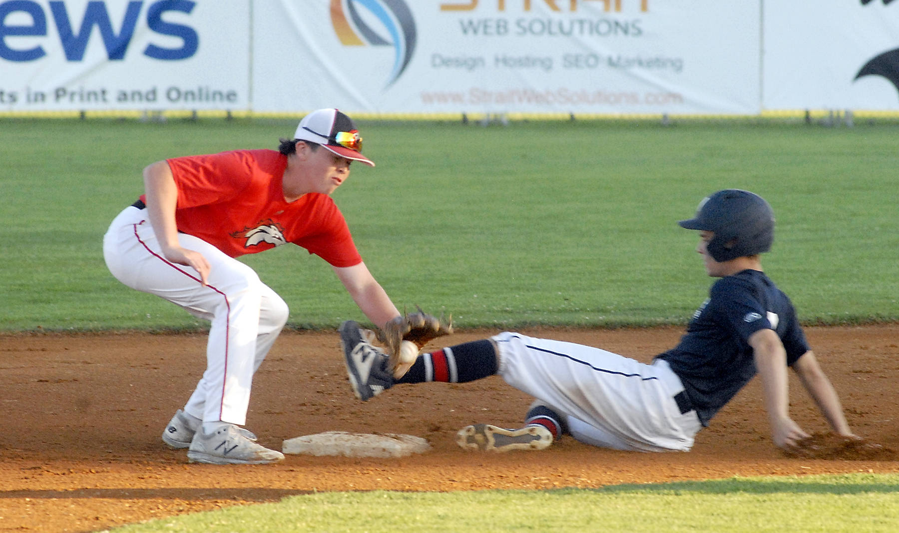 Keith Thorpe/Peninsula Daily News
Wilder's Logan Olson, left, makes it to second, beating the throw toi WBS Colts Red shortstop Grady Smith on Saturday in Port Angeles.