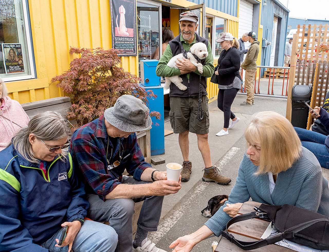 Tony Genovese, center, holding his dog Cleo, enjoys meeting his friends at Sunrise Coffee in Port Townsend on Monday morning. Genovese is a member of the Port Townsend New Friendships Meetup group and has been meeting for coffee and a walk every Monday for the past four years. “It’s wonderful to see the faces of my friends without masks once again,” he said. Seated, from left, are Betty Peterson-Wheeler, Norman Christie and Norma Bishop, all members of the group. (Steve Mullensky/For Peninsula Daily News)